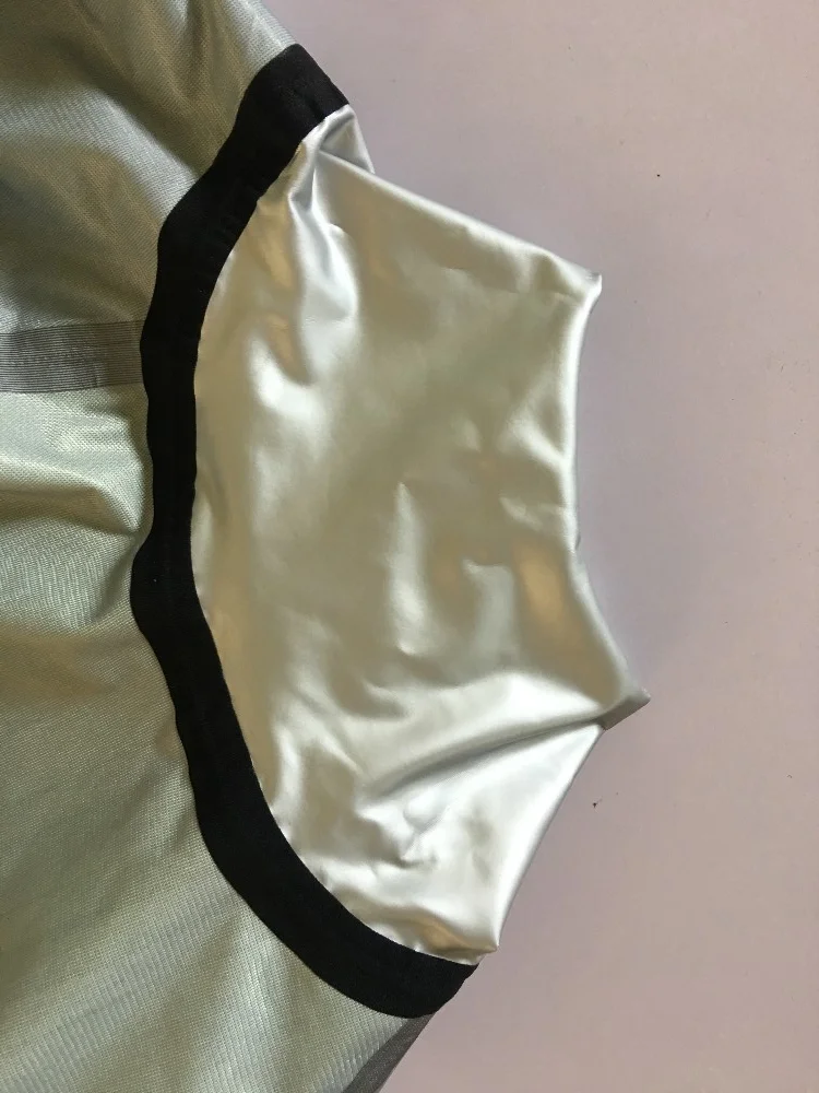 Una elegante prenda de cuello alto con un acabado metálico brillante y un borde negro contrastante