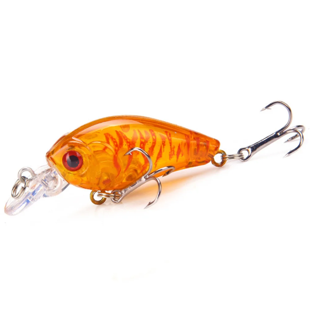 Un vibrante señuelo de pesca naranja con un ojo transparente y múltiples ganchos diseñados para una pesca efectiva