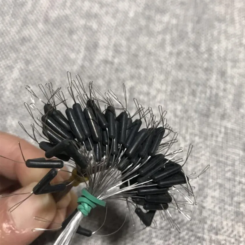 Una persona sostiene un cepillo con cerdas negras y un mango verde