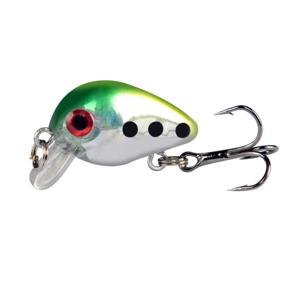 un pequeño señuelo de pesca con un diseño verde y blanco y tres ganchos de agudos