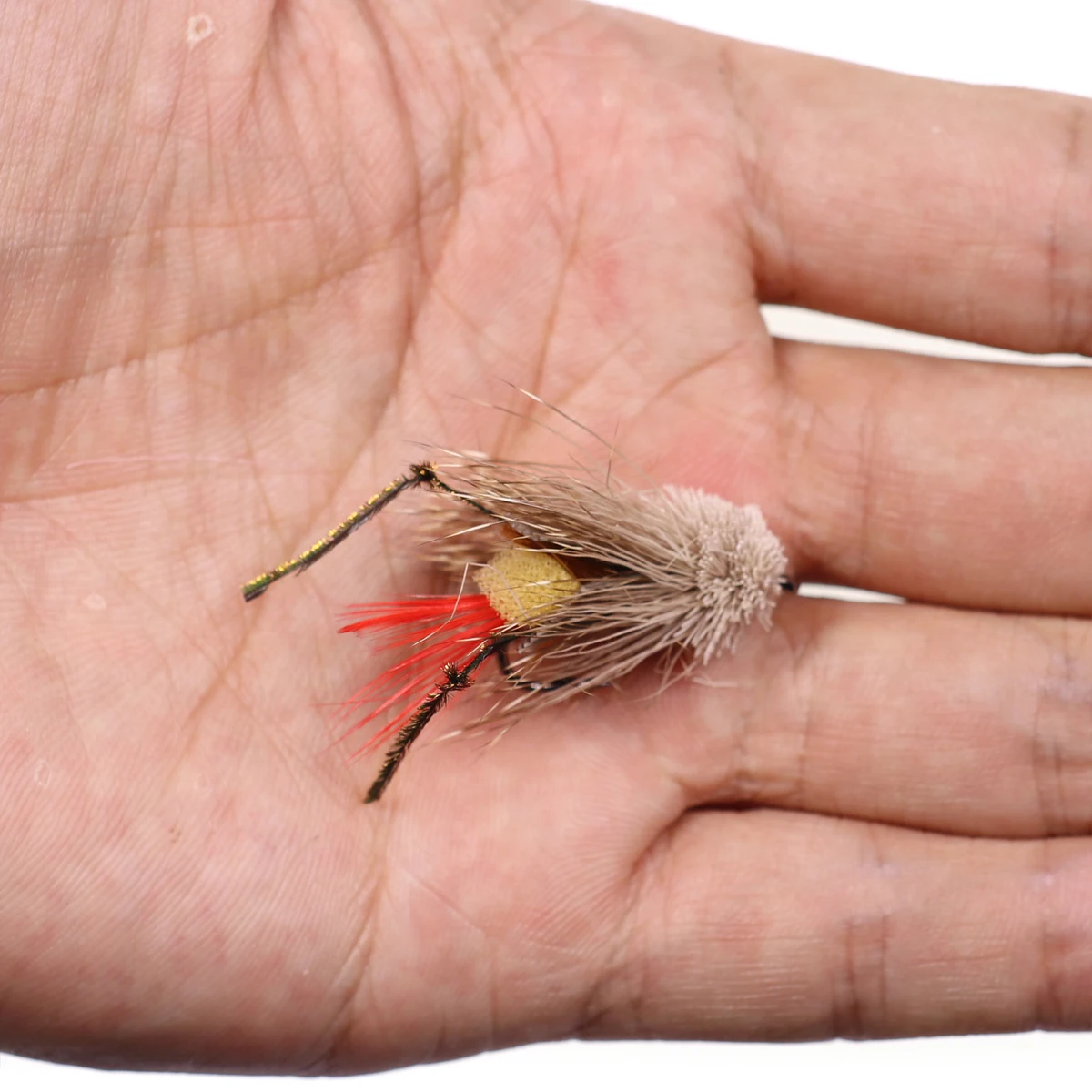 Un delicado señuelo de pesca descansa en una mano lista para la próxima aventura