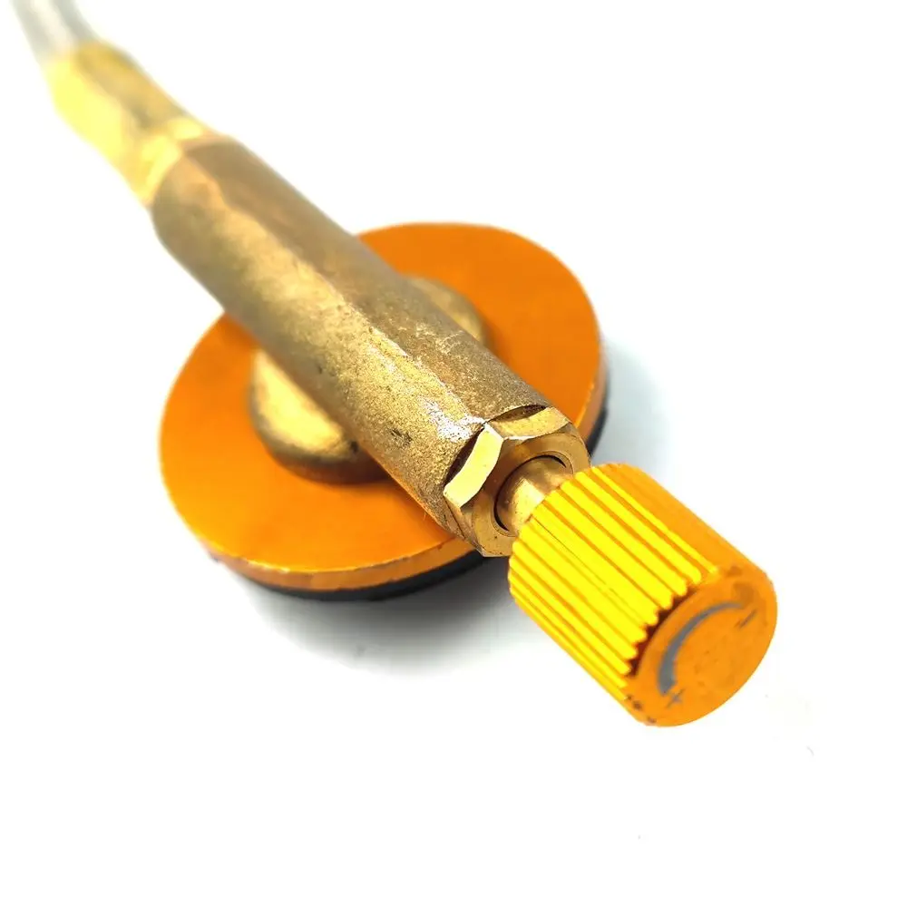 Un dispositivo de latón y de color naranja con una perilla texturizada probablemente una herramienta o un componente para una aplicación específica