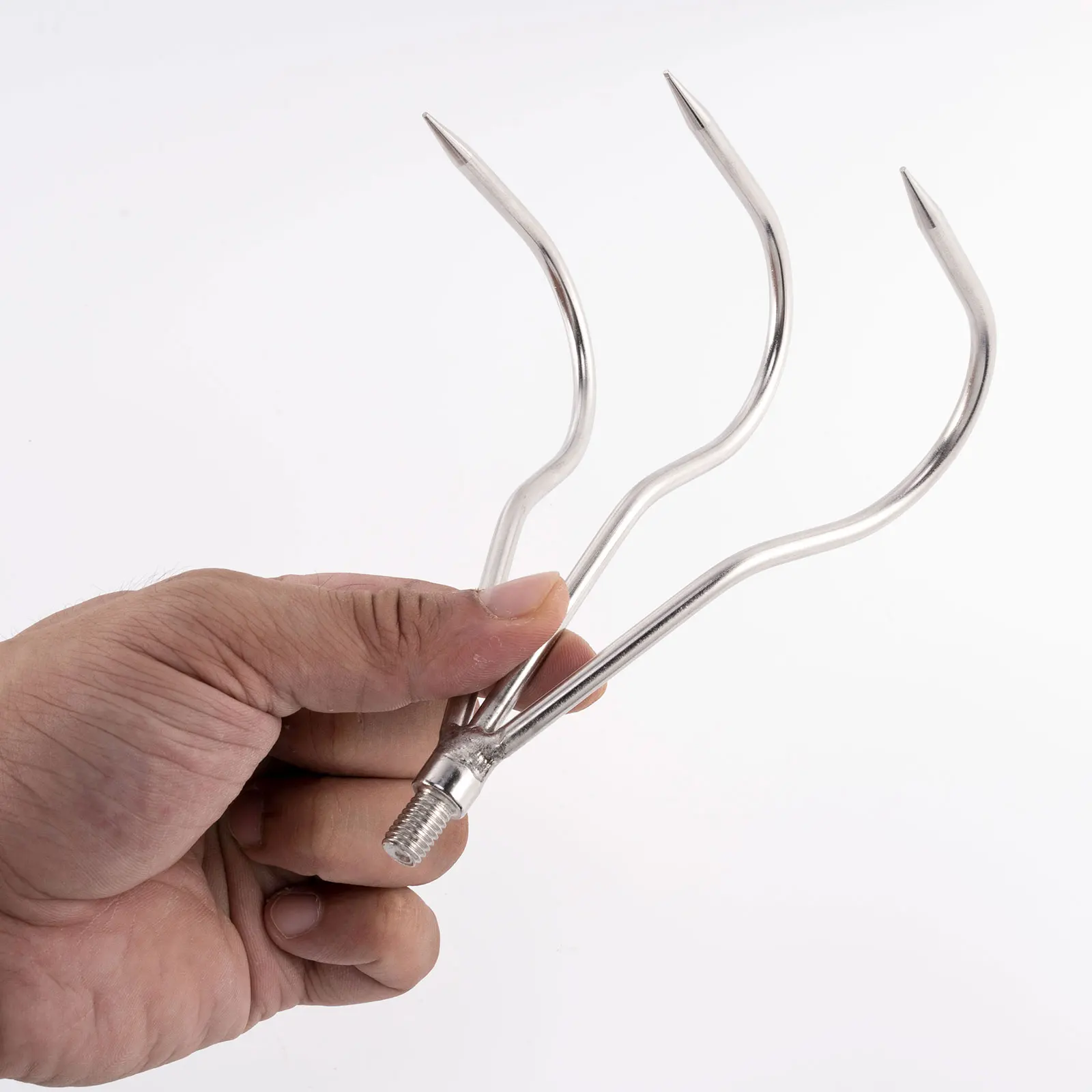 Una mano que sostiene una elegante herramienta metálica con extremos curvos y puntiagudos, ideal para tareas de precisión