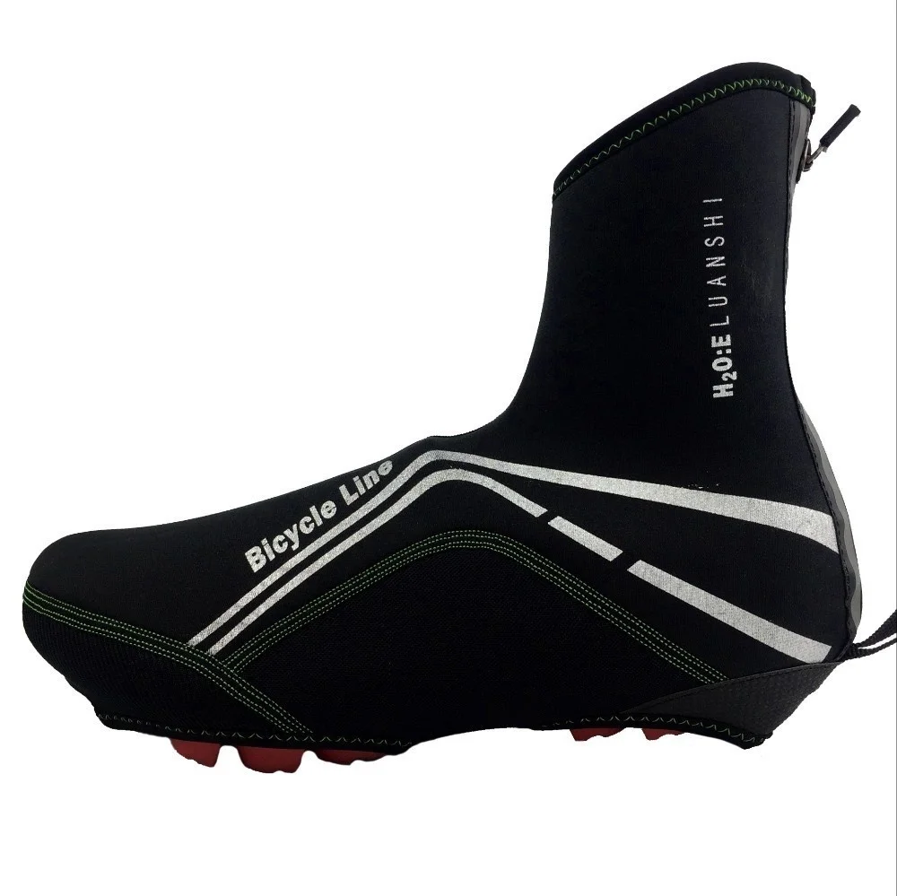 Una zapatilla de ciclismo negra con un diseño en blanco y verde en el lateral. El zapato tiene una suela texturizada, típica de las zapatillas de ciclismo para proporcionar agarre en los pedales.