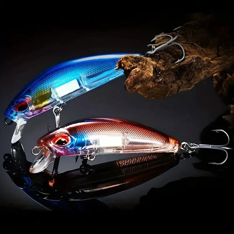 Señuelos minnow wobblers con ojos 3D dispuestos sobre superficie de pesca