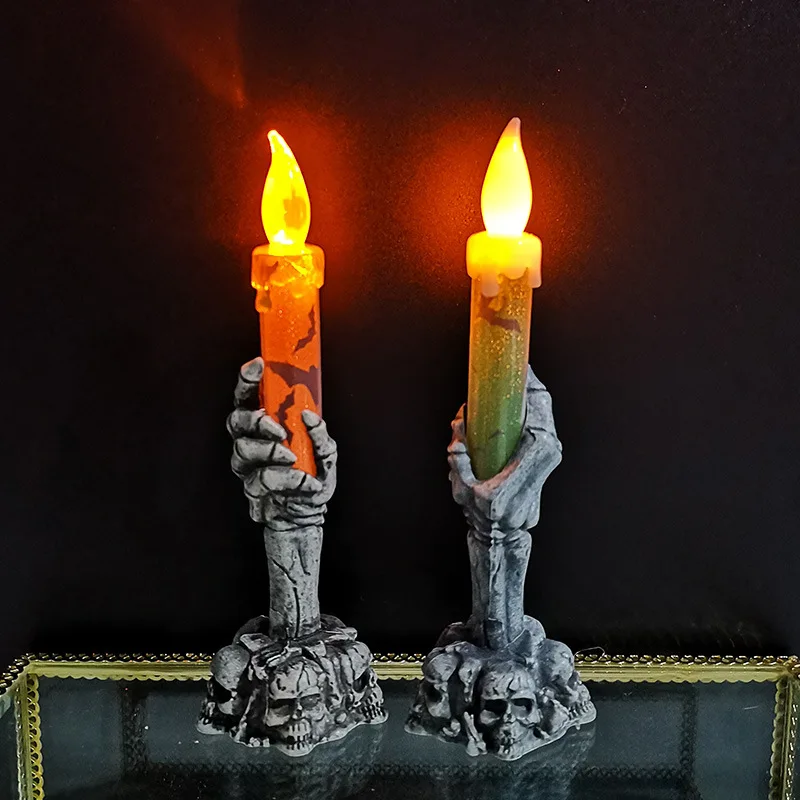 Vela LED Halloween con diseño de calavera en verde y naranja