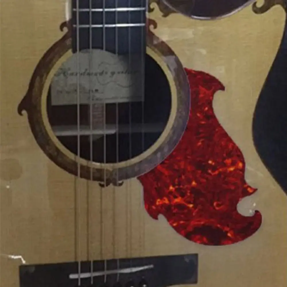 Vista frontal del golpeador sobre guitarra acústica