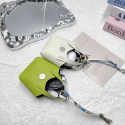 Bolsa para auriculares Bluetooth de cuero PU con llavero portátil