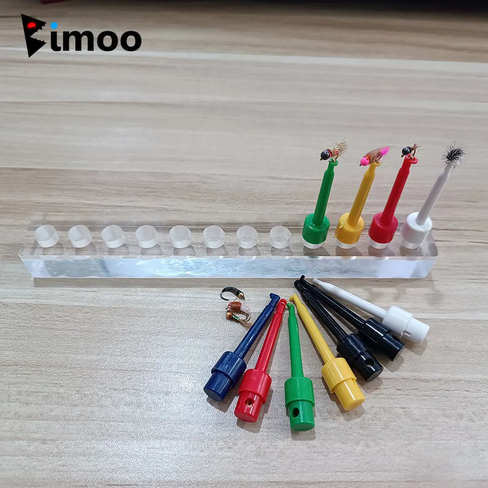 Soporte acrílico transparente con moscas de pesca