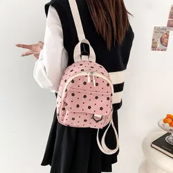Mochila pequeña de pana con estampado floral y bandolera