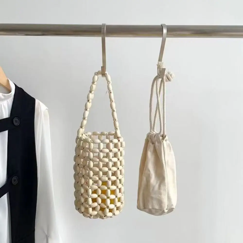 Bolso de mano cilíndrico de madera artesanal con cuentas y asa de lazo - imagen 2